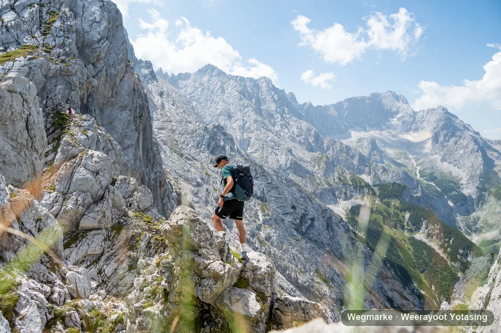 Hiker above a wide alpine valley