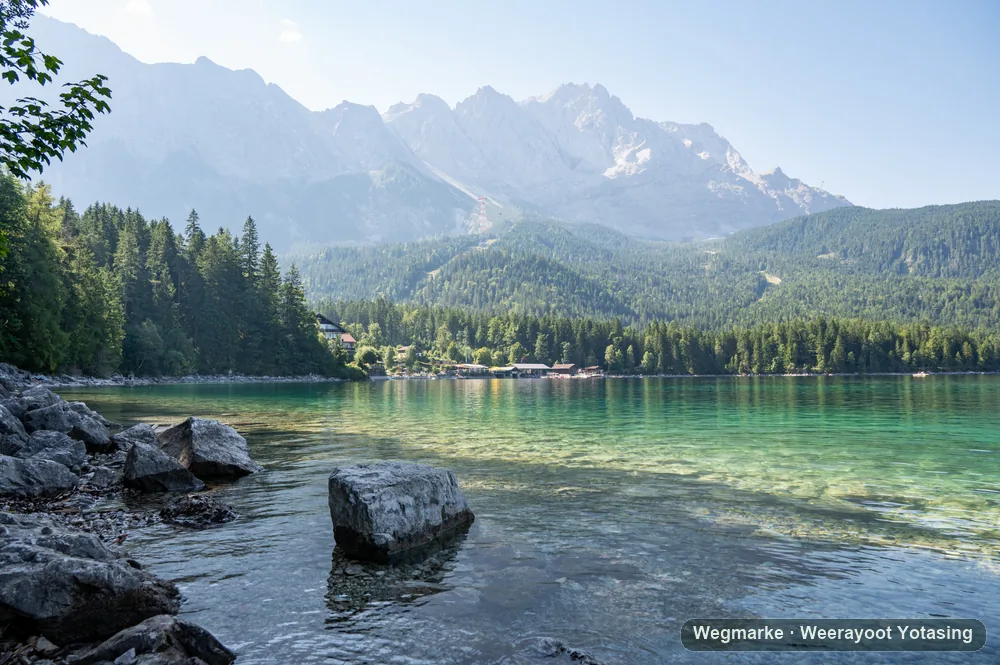 A clear alpine lake below a mountain range